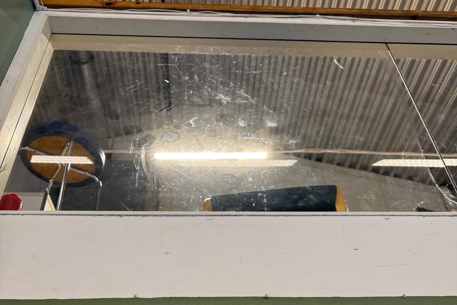Fönster före putsning – glaset är täckt av repor, smuts och fingeravtryck